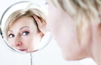 Woman Looking in Mirror